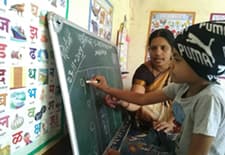 child with deafblindness solving math sum in the mainstream classroom with the support of his class teacher